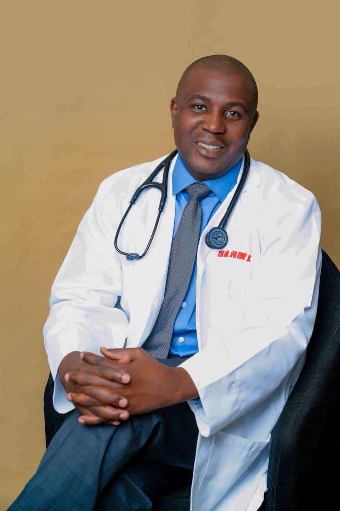 Oseni Abiri, psychiatric mental health nurse practitioner, seated in a white coat with a stethoscope